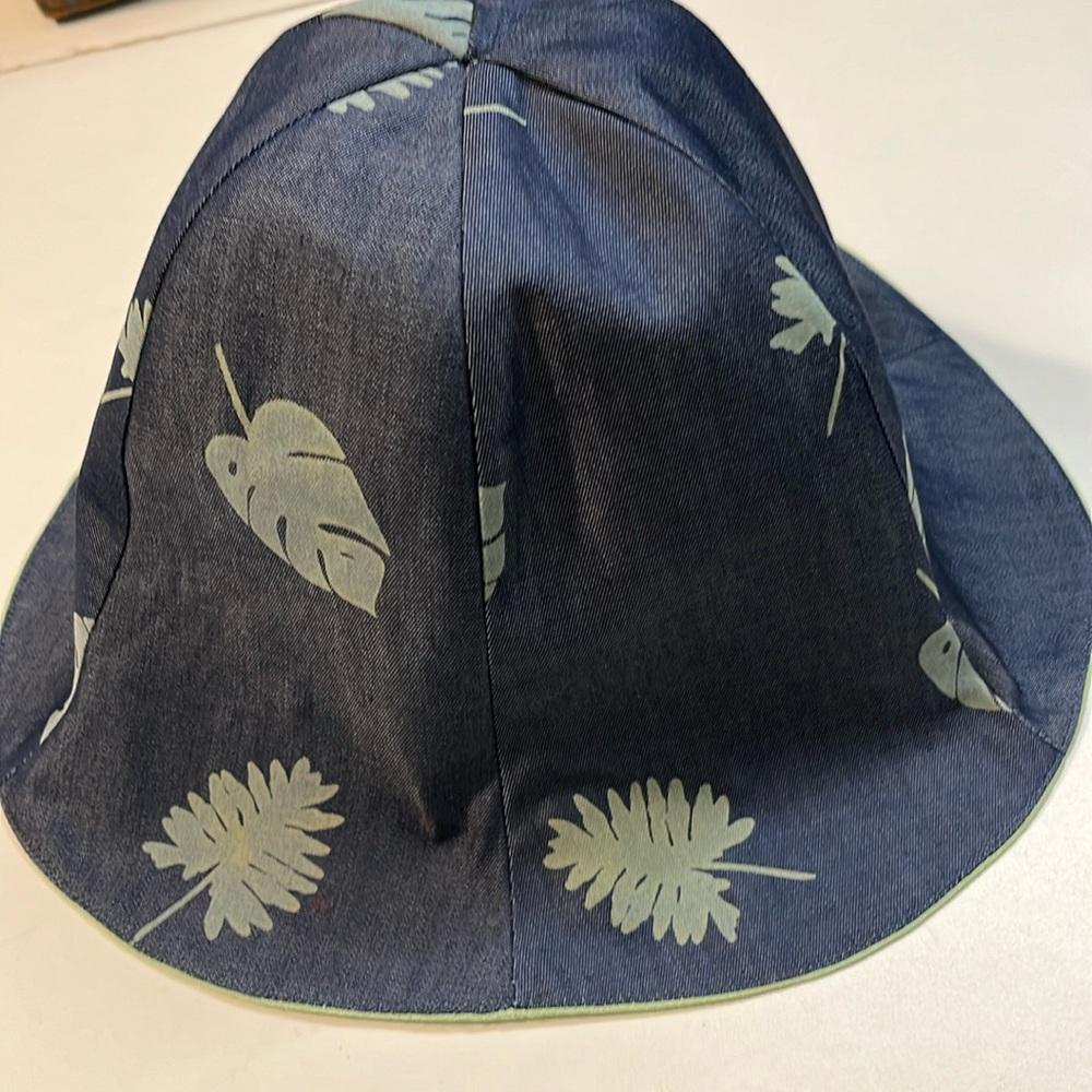denim and green hat